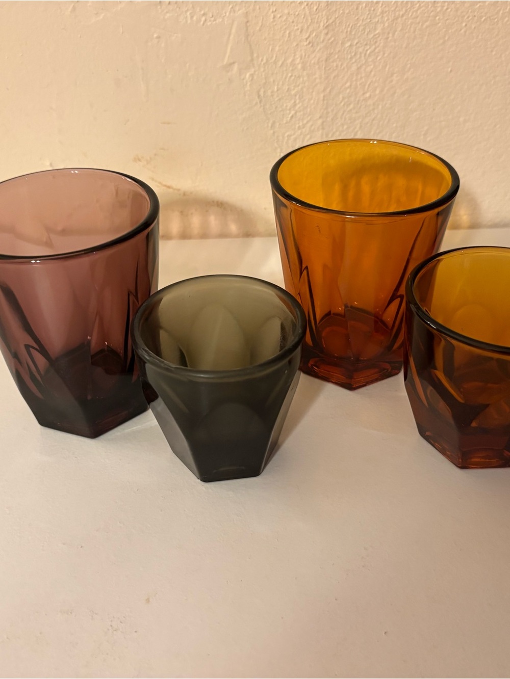 Assorted Faceted Glass Tumblers in Amber, Smoky Gray, and Mauve